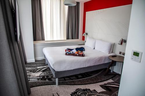 a hotel room with a bed with toy trains on it at ibis Styles Glasgow Central in Glasgow