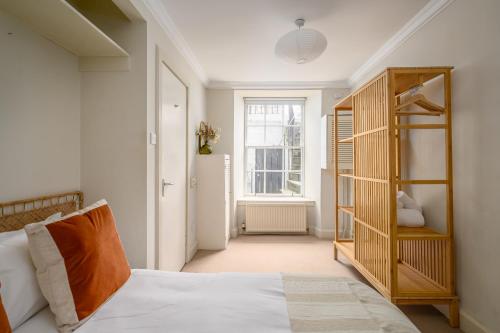 a bedroom with a bed and a book shelf at Retro New Town Garden Flat in Edinburgh