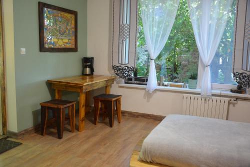 a bedroom with a desk and a bed and a window at Magic Wood Studio Apartament Koniewo in Lidzbark Warmiński