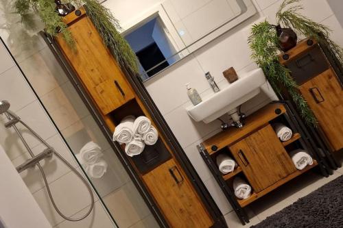 a bathroom with a shower and a sink and towels at Best choice für Grazer Kurztripp in Graz