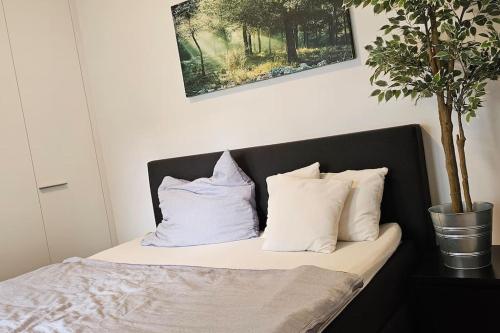 a bed with white pillows on top of it at Best choice für Grazer Kurztripp in Graz