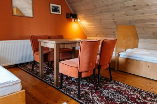 a room with a table and chairs and a bed at HoStel Cosmopolitan* in Banská Štiavnica
