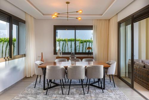 a dining room with a table and chairs at Houd Taghazout - luxury villa - Pool - 6 or 7 Px in Taghazout