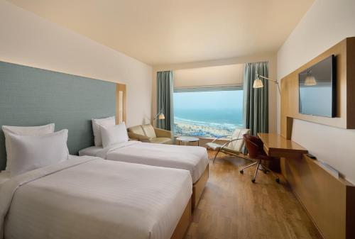 Кровать или кровати в номере Novotel Visakhapatnam Varun Beach