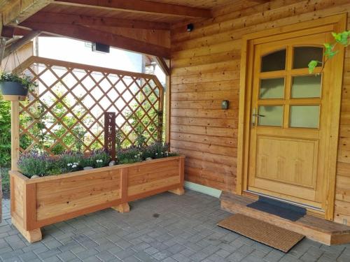 a wooden house with a porch with a wooden door at Ferienhäuschen in Mariahof in Mariahof