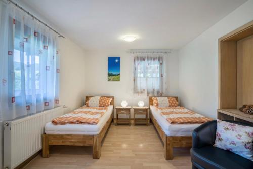 a room with two beds and a couch at Ferienwohnung Ohnemus in Schuttertal