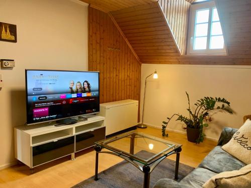 a living room with a large flat screen tv at Ferienwohnung Cäcilia im idyllischen Haus Kommeles - Leiwen an der Mosel in Leiwen