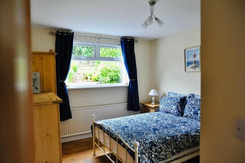 a bedroom with a bed and a window at Crebilly Cottage - Rural Life doesn't get better in Ballymena