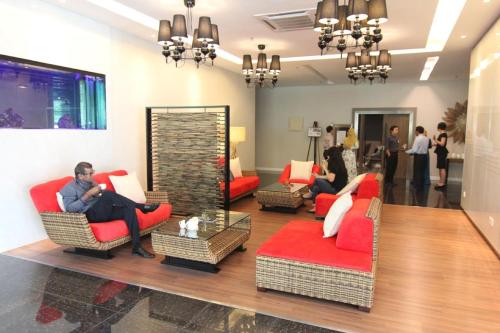 a group of people sitting in chairs in a lobby at Townhouse OAK 591 Shah Alam By Salaam Suites in Shah Alam