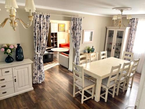 a dining room and living room with a table and chairs at Holiday Home Barska Vila in Bar