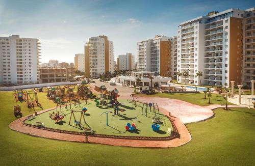an aerial view of a playground in a city at Amadeus Holiday Apartments in Caesar Resort & SPA, Long Beach in Perivolia tou Trikomou