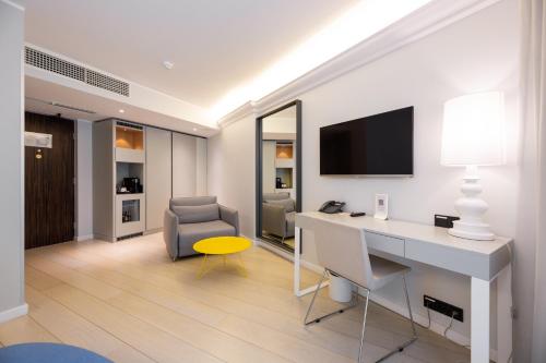a room with a desk and a chair and a television at ibis Styles Tallinn in Tallinn