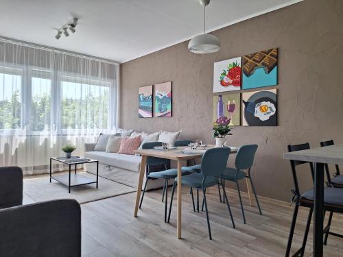 a living room with a table and a couch at Kavics Apartman Tata in Tata