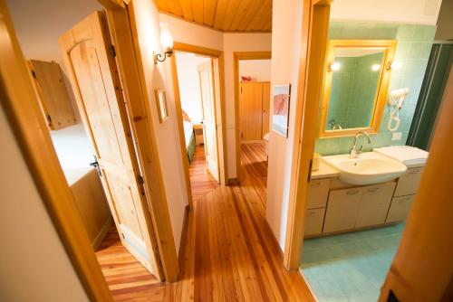 a bathroom with a sink and a mirror at Chalet Elena in Livigno