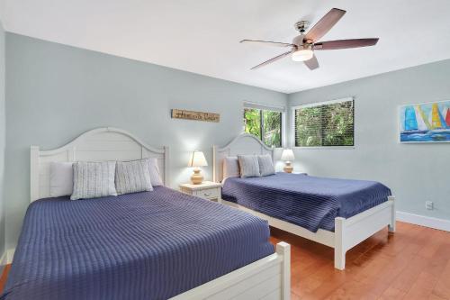a bedroom with two beds and a ceiling fan at A Private Oasis Complex in Naples in Naples