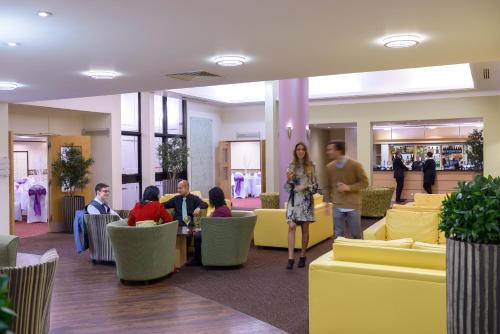 a group of people sitting in a lobby at Cranfield Management Development Centre in Cranfield