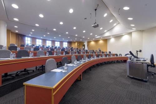 a large room with rows of tables and chairs at Cranfield Management Development Centre in Cranfield