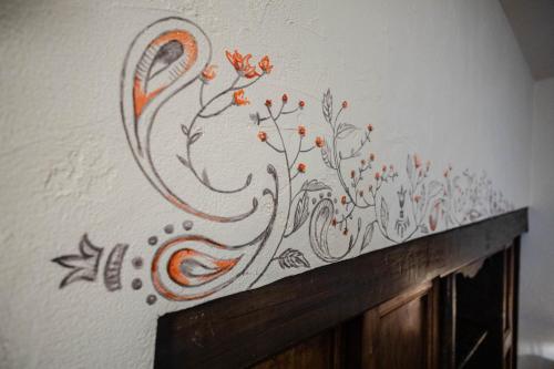 a wall with a painting of flowers on it at Domus Antica Aosta in Aosta