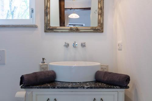 a bathroom with a sink and a mirror at Piemonte Country House in Agliano Terme