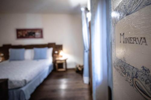 a bedroom with a bed and a sign on a wall at Domus Antica Aosta in Aosta
