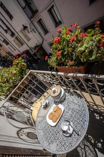 a table with a plate of bread on it on a balcony at Domus Antica Aosta in Aosta