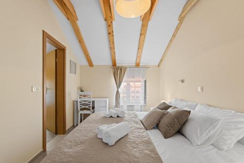 a bedroom with a large white bed with two towels at Apartman Žužić in Novigrad Istria