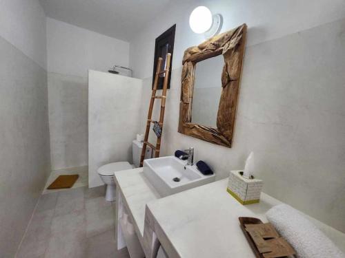 a bathroom with a sink and a toilet and a mirror at Villa Agua 3 in Agua de Bueyes