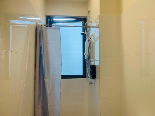 a bathroom with a shower curtain and a window at CoreSoho Suite by BKAstaycation KotaWarisan Sepang KLIA Airport, Free Wifi in Sepang