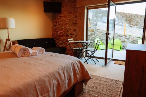 a bedroom with a bed with towels on it at Casa do avô tamanqueiro in Arco de Baúlhe