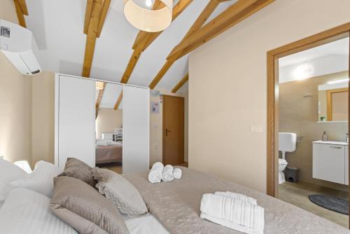 a bedroom with a bed with two pillows on it at Apartman Žužić in Novigrad Istria