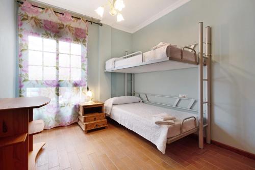 a bedroom with two bunk beds and a window at Brisa del Mar in Guía de Isora