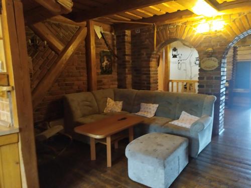 a living room with a couch and a table at Ubytování U Bohouše in Jilemnice