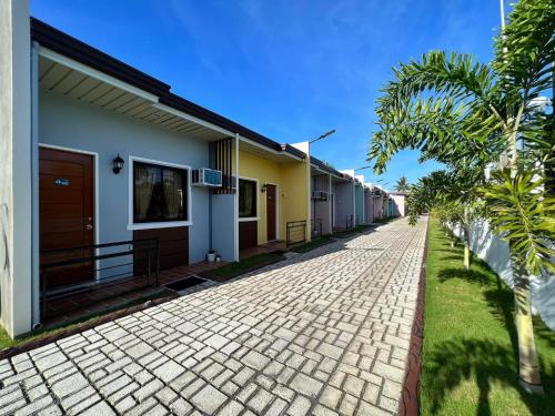 a cobblestone street in front of a row of houses at SUNSHINE STAY PANGLAO in Panglao