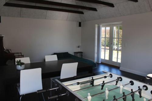 a room with a ping pong table and chairs at Large modern family room - “Arnely” in Tommerup