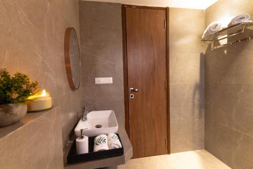 a bathroom with a sink and a toilet and a mirror at Villa Amara 30 by Stay ALYF, Lonavala in Lonavala