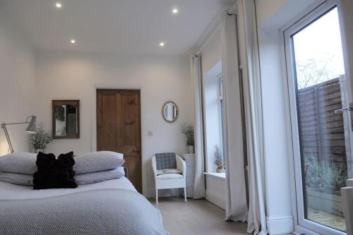 a bedroom with a bed and a large window at The Snug in Riccall