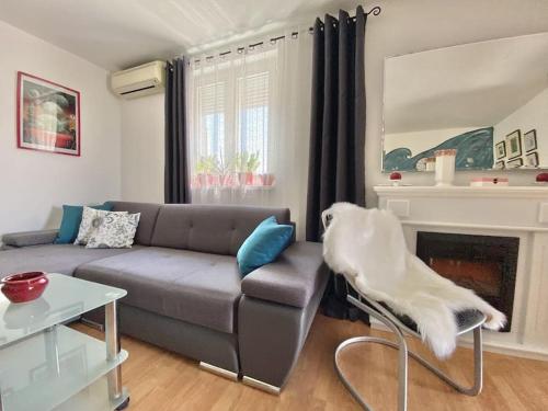a living room with a couch and a fireplace at Lovely Apartment Marina Blue in Skrbčići