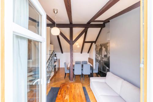 a living room with a white couch and a table at Janackovo - Riverside Residence in Prague