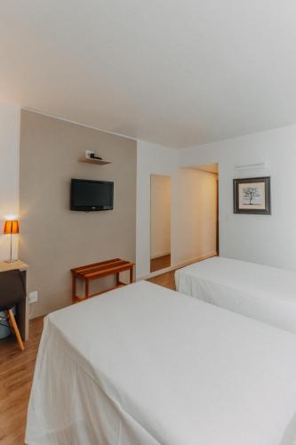 Ένα ή περισσότερα κρεβάτια σε δωμάτιο στο Antonio´s Palace Hotel