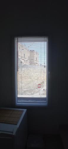 a window in a room with a view of a building at La loggetta 63 in Palagianello