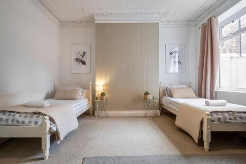 Säng eller sängar i ett rum på Spacious Apartment in Jesmond with Parking