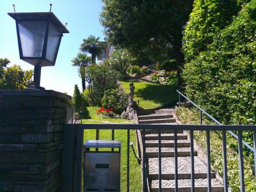 a gate with a street light next to a stairway at Lakeviewcabin in Como