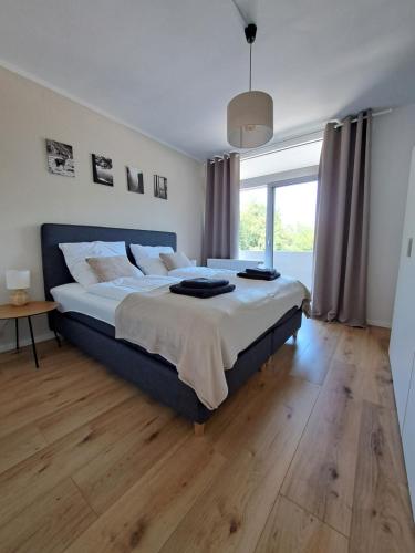 a large bedroom with a large bed and wooden floors at Harz-Glück-Fewo in Bad Harzburg