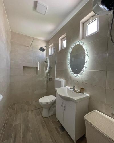 a bathroom with a toilet and a sink and a mirror at Casa Gazi in Ulcinj