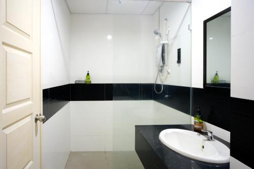 a white bathroom with a sink and a mirror at Mansion One l 4pax Studio A l Cityview l Gleneagle l by PerfectSweetHome in George Town