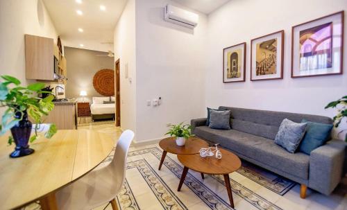 a living room with a couch and a table at L1-cm Loft Apartment In Getsemani With Air Conditioning Pool And WIFI in Cartagena de Indias