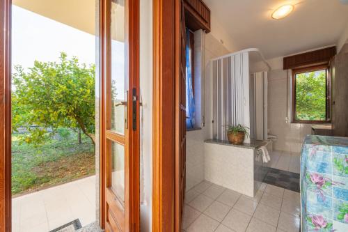 an open door to a bathroom with a window at Casa Vacanze San Giovanni in San Giovanni Suergiu