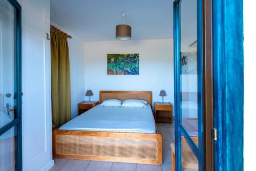 a bedroom with a bed and a glass door at Villa Amerita in Elia Laconias