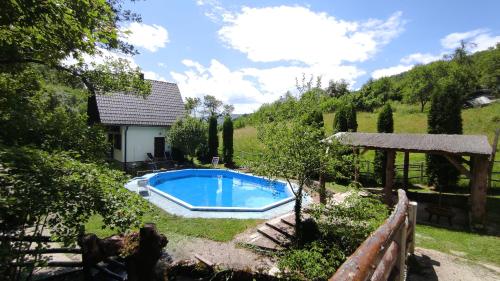 a swimming pool in the yard of a house at Apartman Mitrić in Šipovo