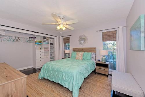 a bedroom with a bed and a ceiling fan at Family friendly with large pool in Sarasota
